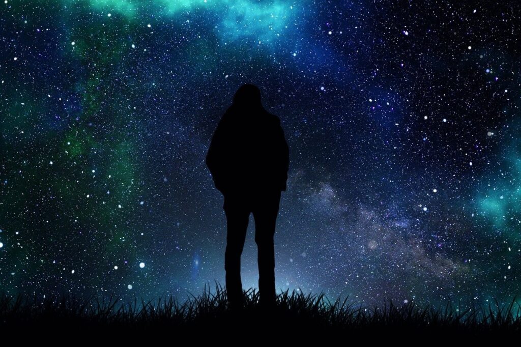 Man standing against starlit sky